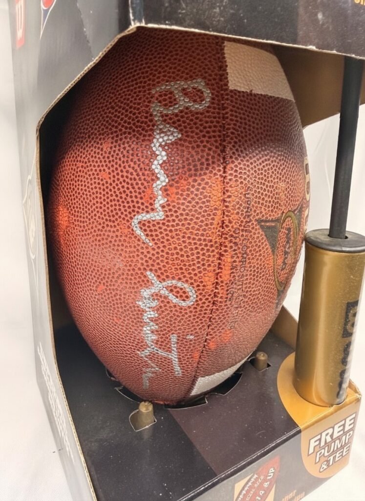 Wilson NCAA Supreme football in original display box showing silver Barry Switzer autograph and gold Wilson hand pump