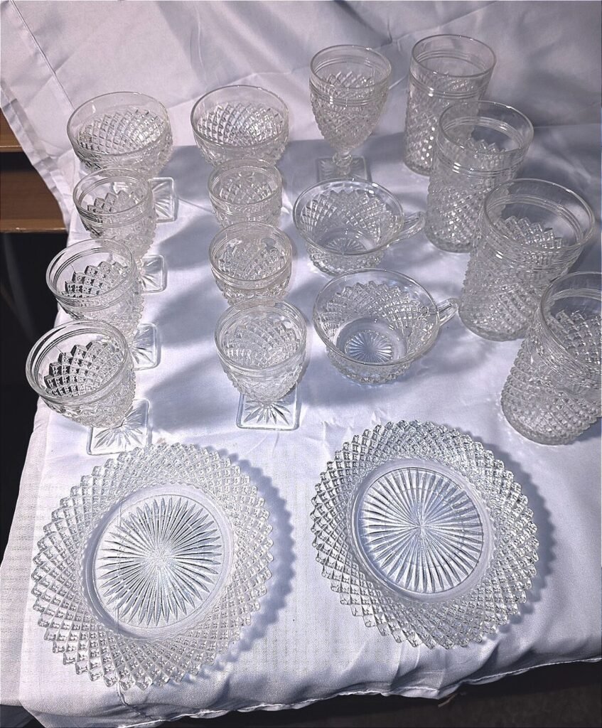 Overhead view of 17-piece Anchor Hocking Miss America crystal set showing plates, goblets, tumblers and sherbets.