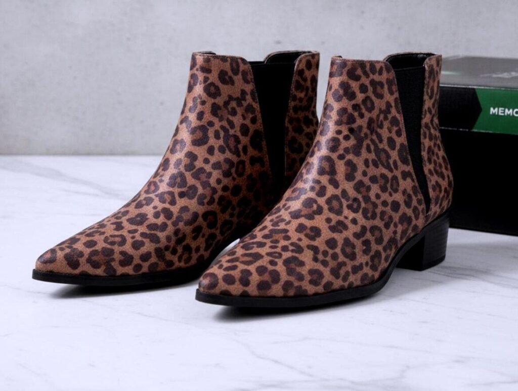Pair of a.n.a leopard print ankle boots, front-left three-quarter view showing pointed toes, elastic side panels and low block heels