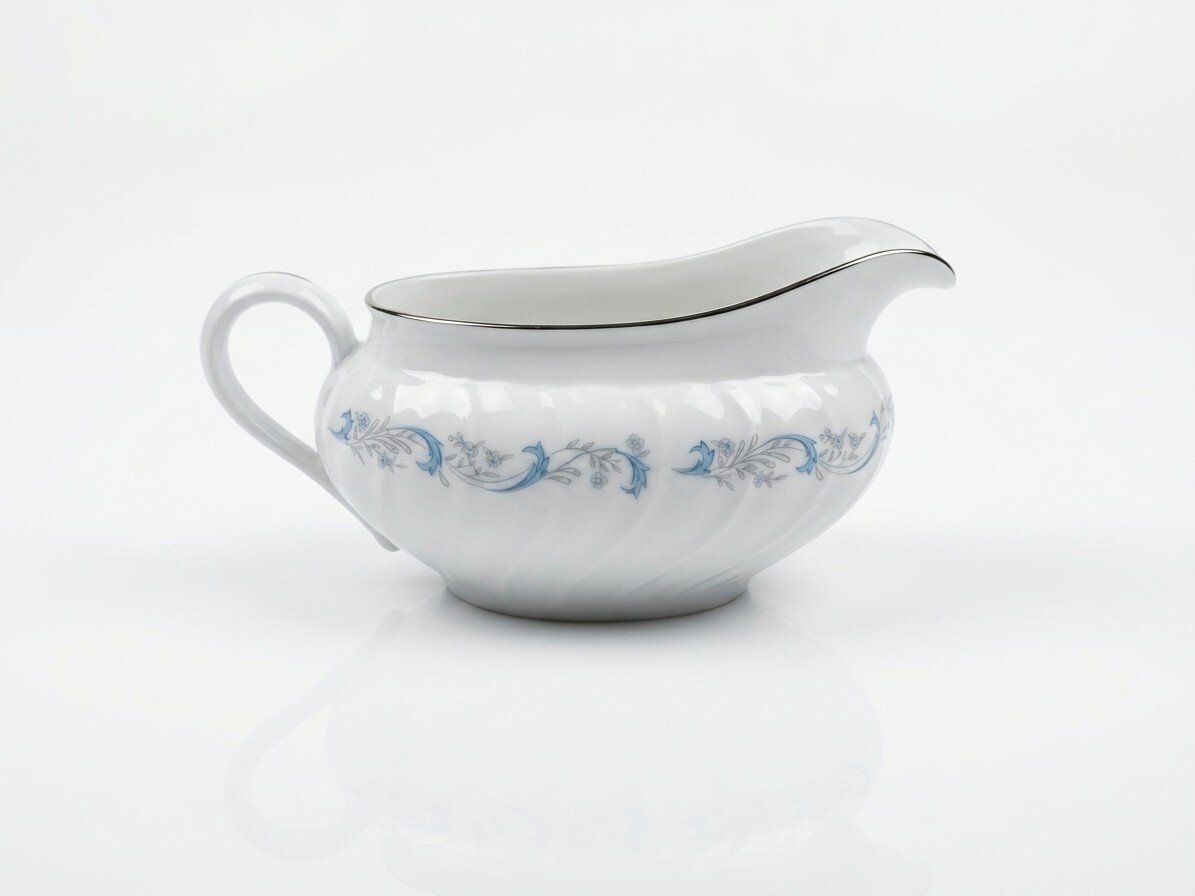 White Camelot China Gracious gravy boat, side profile showing blue floral scroll band and silver-trimmed rim.