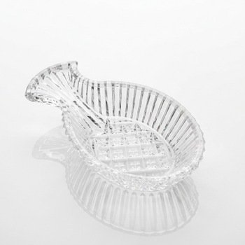 Clear pressed-glass pineapple spoon rest, three-quarter top view highlighting vertical ribbing and diamond-point center.