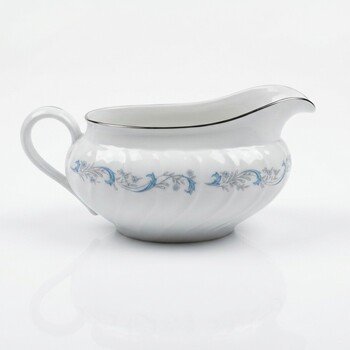 Angle view of the Camelot China Gracious gravy boat showing handle, spout, swirl body and blue floral pattern with silver rim.